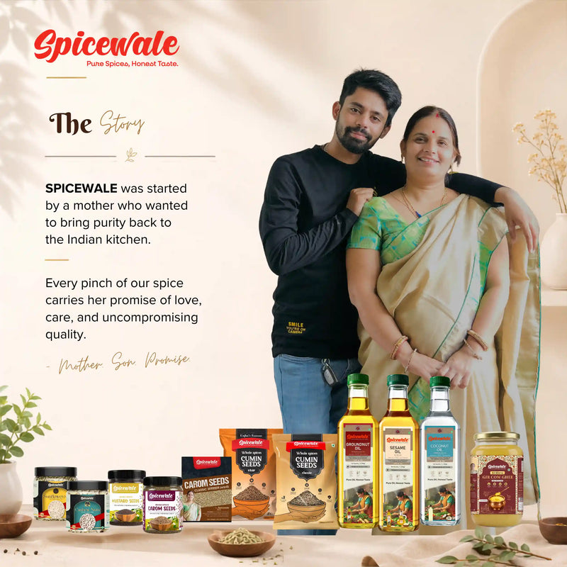 Spicewale 'The Story' banner featuring the brand's founders, a mother and her son, standing together beside a collection of Spicewale spices, cooking oils, and A2 ghee products. The banner shares the brand's story of bringing purity back to the Indian kitchen through love, care, and uncompromising quality, set against a warm, minimalist background.